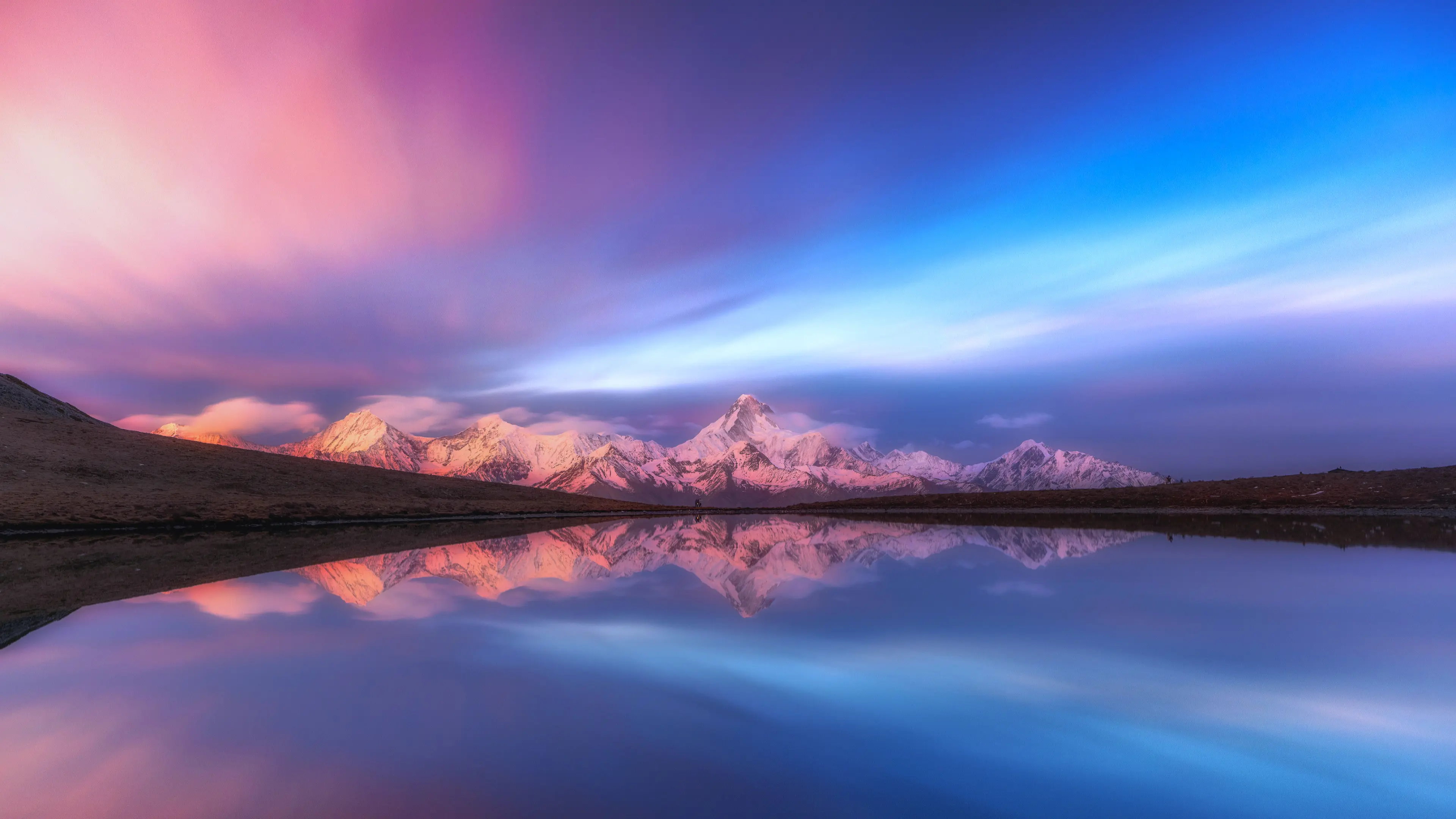 Mountain landscape with purple-tinted lighting, soft clouds above, and a calm, peaceful atmosphere