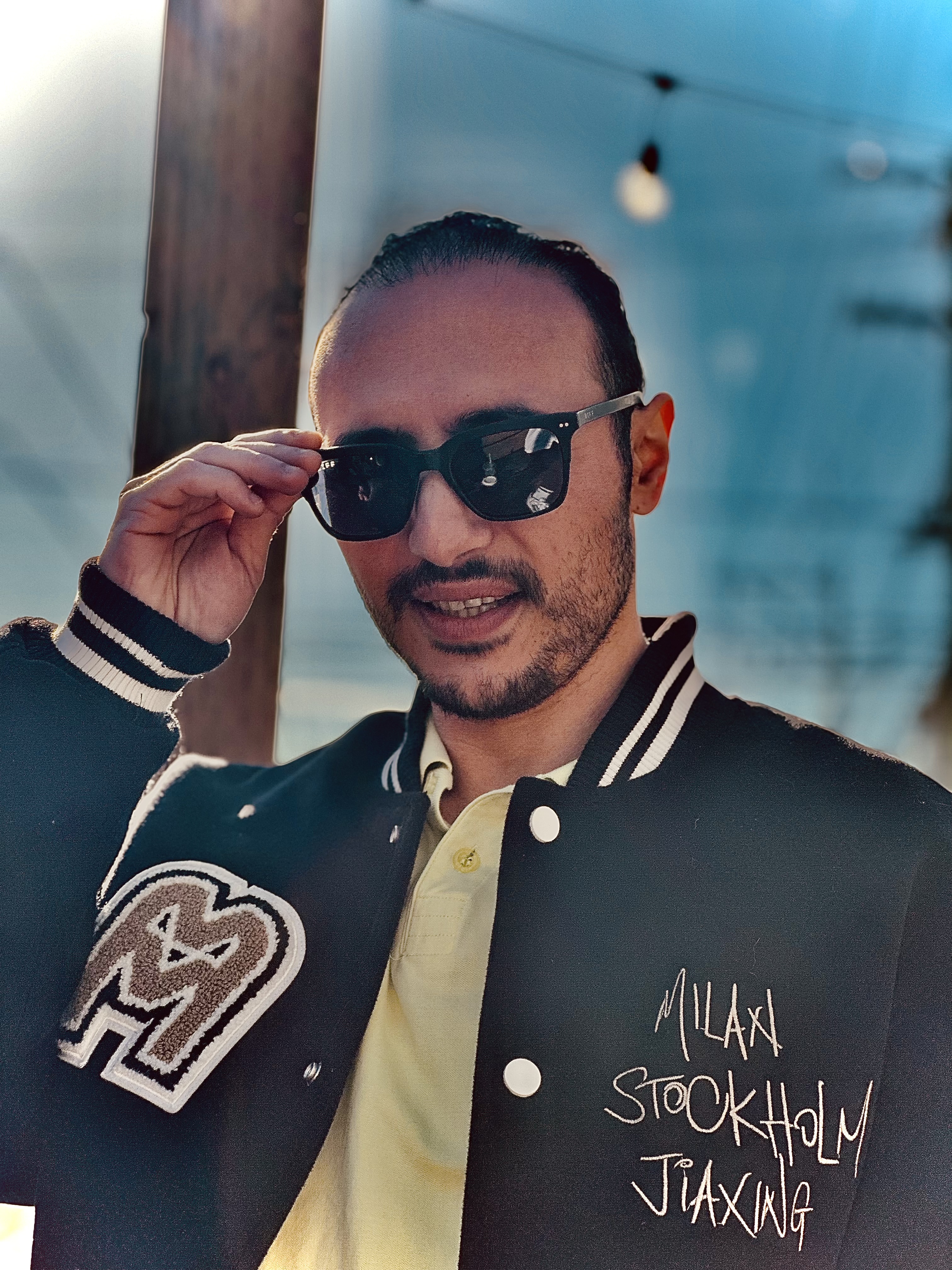 Ahmet Sahiner wearing a black jacket standing outside.