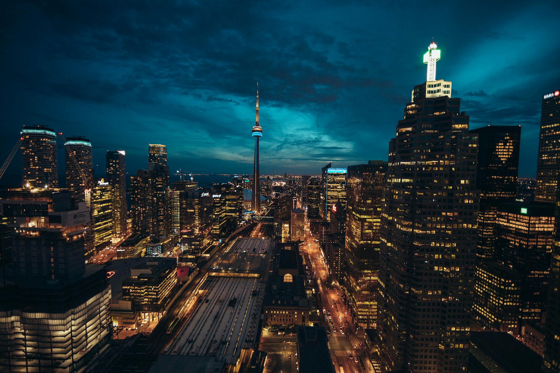 Skyline of a city at night with tall illuminated buildings
